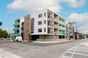 Chula Vista apartment for rent - A white van is parked in front of a multi-story building with a sign that says "EMI LEASING".